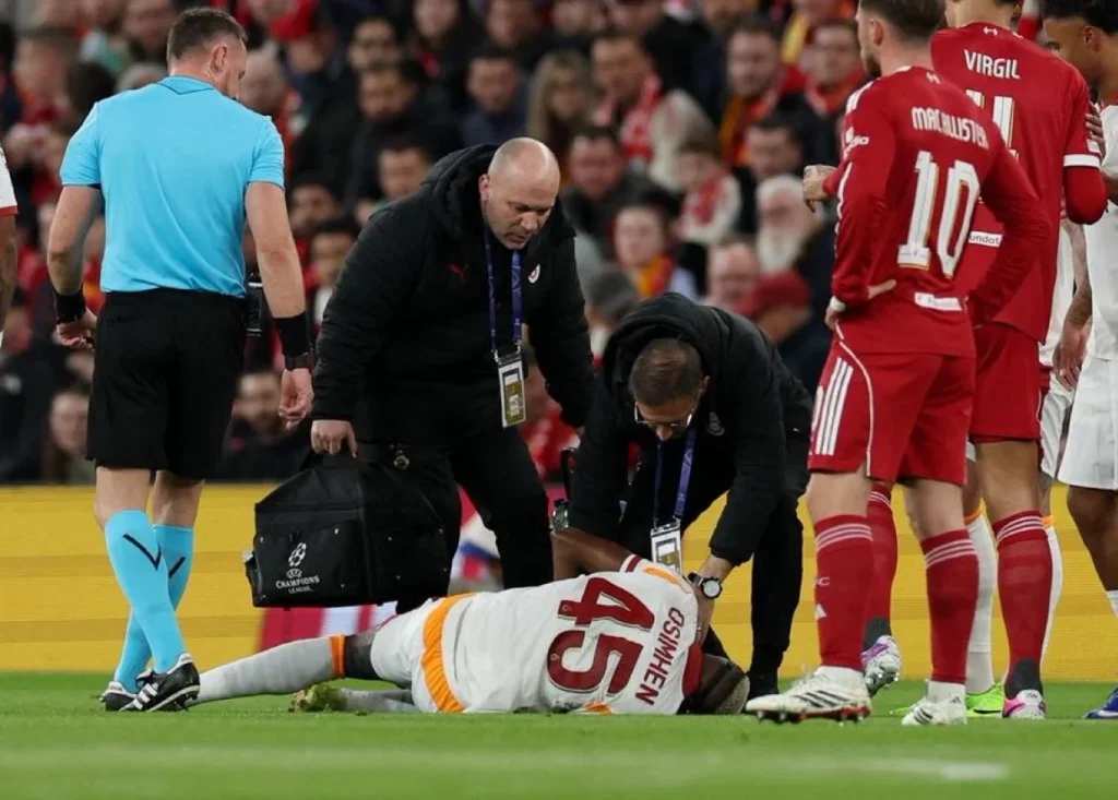 Injured football player being helped off the pitch
