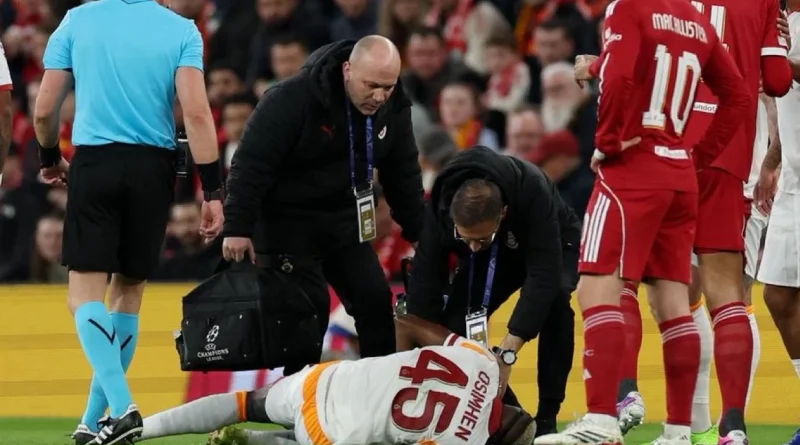 Injured football player being helped off the pitch